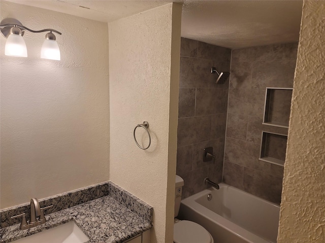 4859 Cedar Springs Rd Unit 147, Dallas, TX 75219 - bathroom with shower / washtub combination, a textured wall, vanity, and toilet