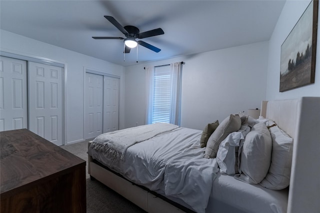 bedroom featuring a ceiling fan, carpet flooring, and two closets