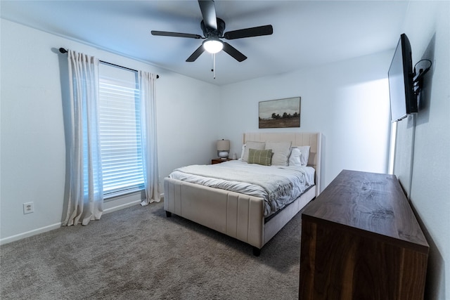 carpeted bedroom with ceiling fan and baseboards