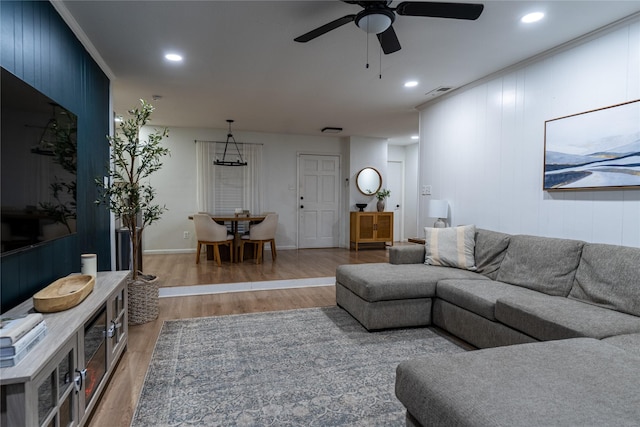 living room featuring visible vents, a ceiling fan, light wood-style flooring, and recessed lighting