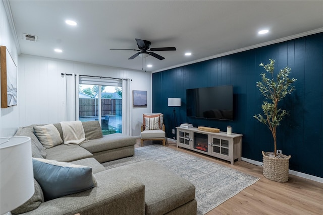 living area with recessed lighting, wood finished floors, visible vents, a ceiling fan, and crown molding