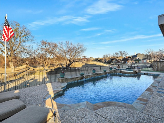 view of swimming pool featuring a patio, a fenced backyard, and a pool with connected hot tub