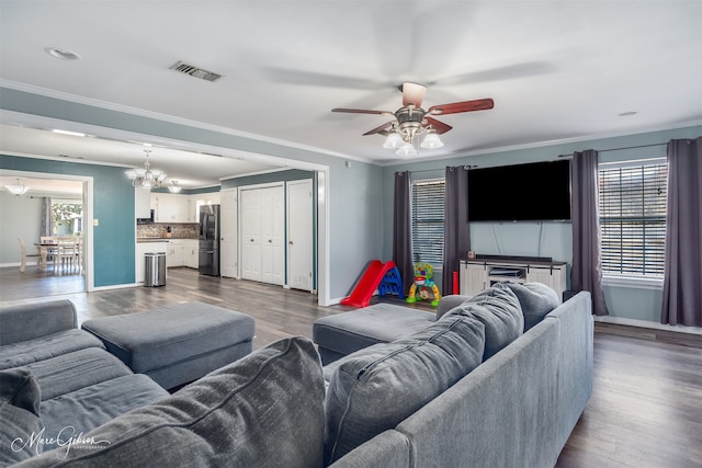 living room with ornamental molding, visible vents, dark wood finished floors, and baseboards