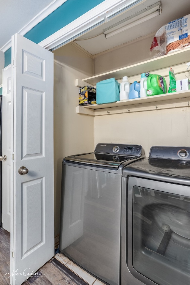 laundry room with washer and dryer, laundry area, and wood finished floors