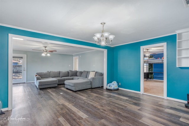 living room featuring ornamental molding, dark wood-style flooring, baseboards, and ceiling fan with notable chandelier