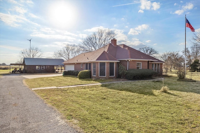 ranch-style house with aphalt driveway, brick siding, a chimney, a garage, and a front lawn