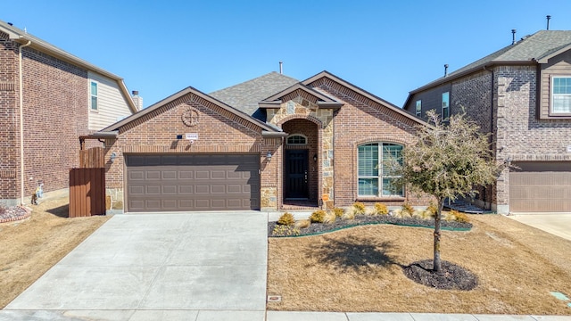 view of front of home with brick siding, driveway, and an attached garage