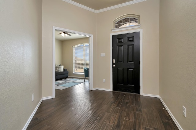 entrance foyer with crown molding, baseboards, and wood finished floors