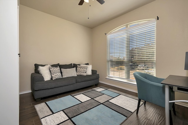 living area with wood tiled floor, baseboards, and a ceiling fan