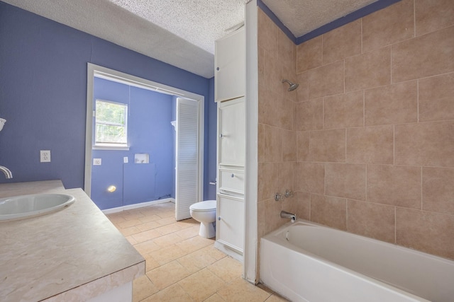 bathroom featuring a textured ceiling, toilet, washtub / shower combination, and vanity