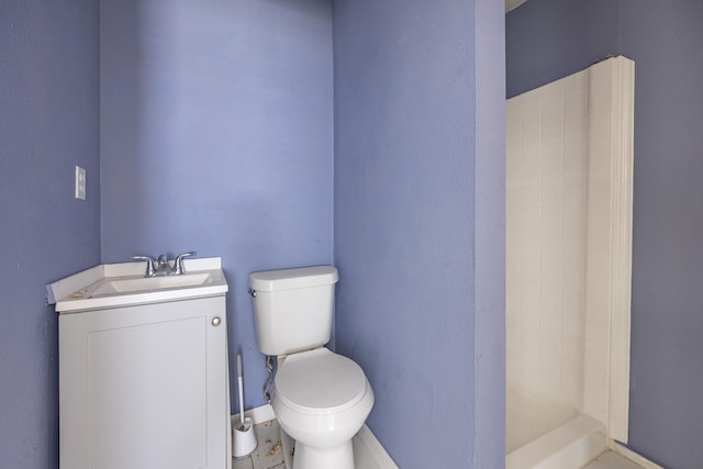 bathroom featuring a stall shower, vanity, and toilet