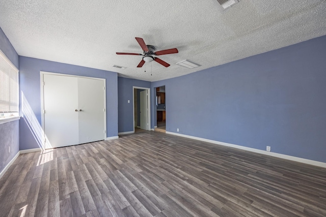 unfurnished bedroom with baseboards, visible vents, and wood finished floors