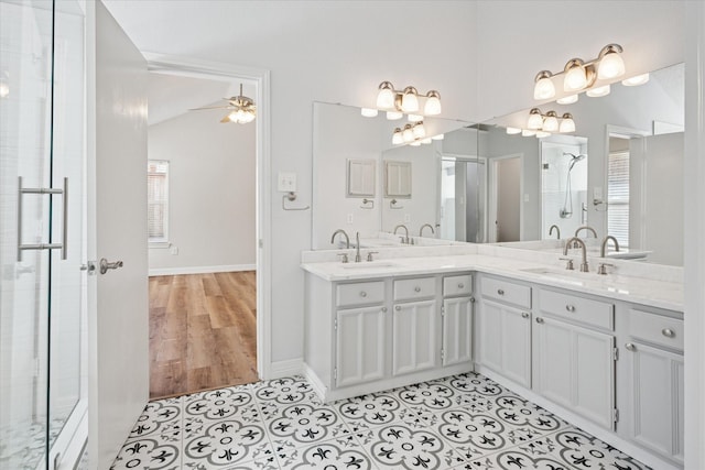 bathroom featuring double vanity, tile patterned flooring, a sink, and a shower with shower door