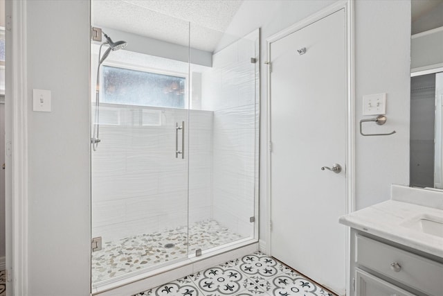 full bathroom with a stall shower, tile patterned floors, and vanity