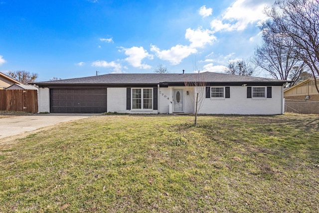 ranch-style house featuring an attached garage, driveway, fence, and a front yard