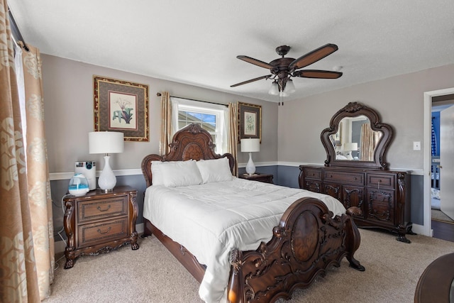 bedroom featuring baseboards, a ceiling fan, and light colored carpet