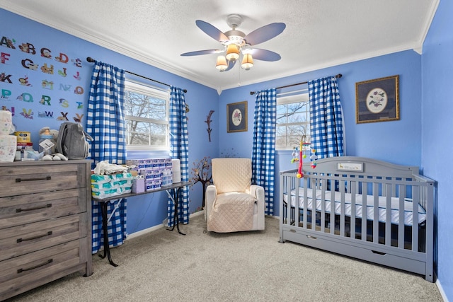 bedroom featuring multiple windows, a textured ceiling, and carpet flooring