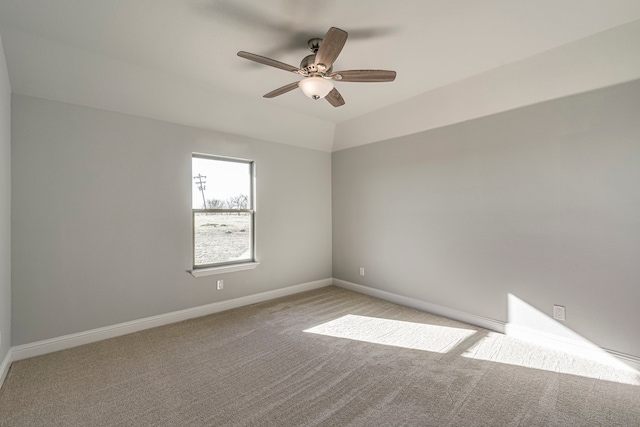 carpeted empty room with ceiling fan and baseboards