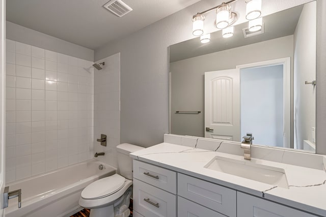 full bathroom featuring washtub / shower combination, visible vents, vanity, and toilet