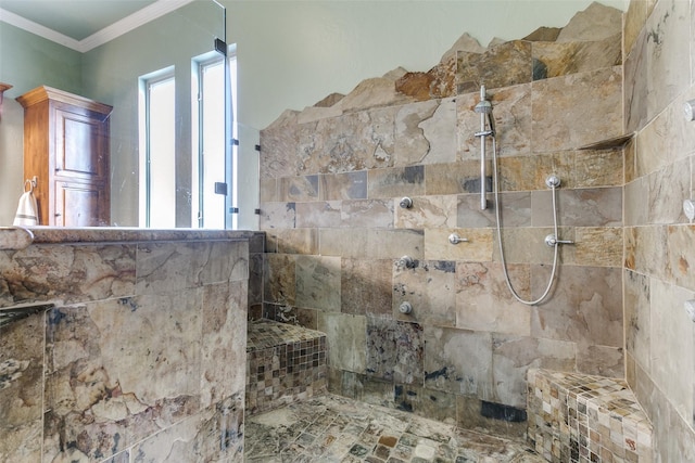 bathroom featuring ornamental molding, a wealth of natural light, and tiled shower