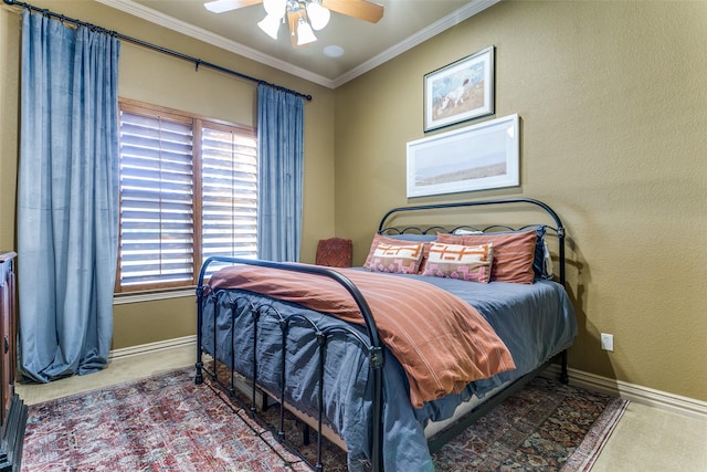 bedroom with ornamental molding, carpet flooring, ceiling fan, and baseboards