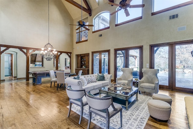 living area featuring a wealth of natural light, french doors, visible vents, and wood finished floors