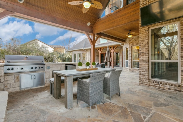 view of patio featuring a ceiling fan, area for grilling, grilling area, outdoor dining area, and a sink