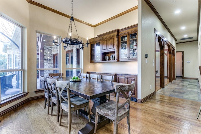 dining space with light wood-style floors, a wealth of natural light, and baseboards