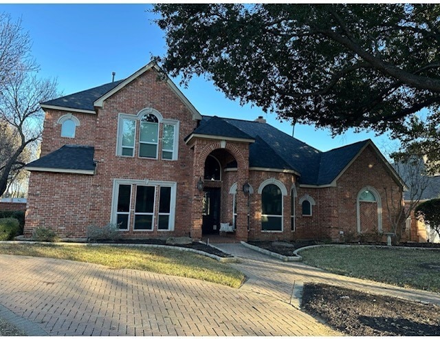 traditional-style house featuring brick siding