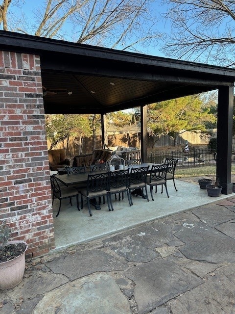 surrounding community with outdoor dining area, a patio area, and fence