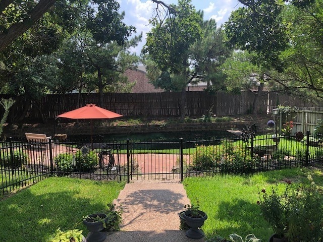 exterior space featuring a lawn and fence