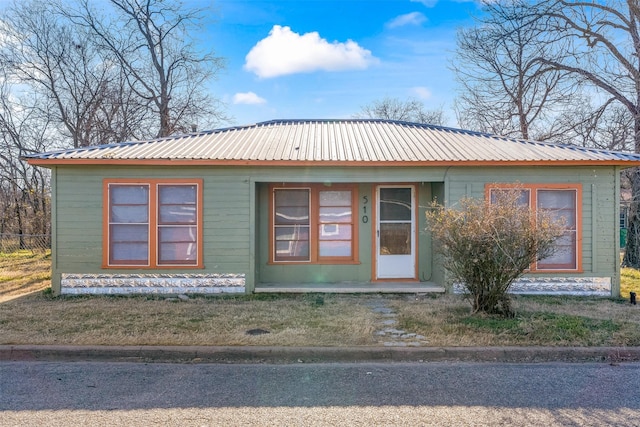 view of front facade with covered porch and metal roof