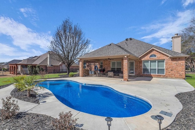 view of pool with a ceiling fan, a fenced in pool, a patio area, and fence