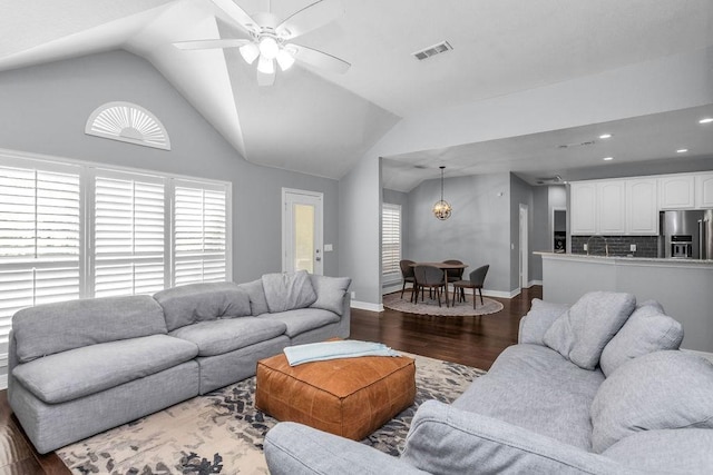 living room featuring visible vents, baseboards, lofted ceiling, dark wood-style floors, and ceiling fan