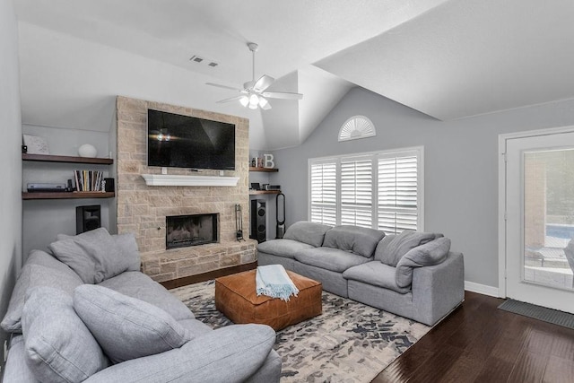 living room with a fireplace, lofted ceiling, visible vents, a ceiling fan, and wood finished floors