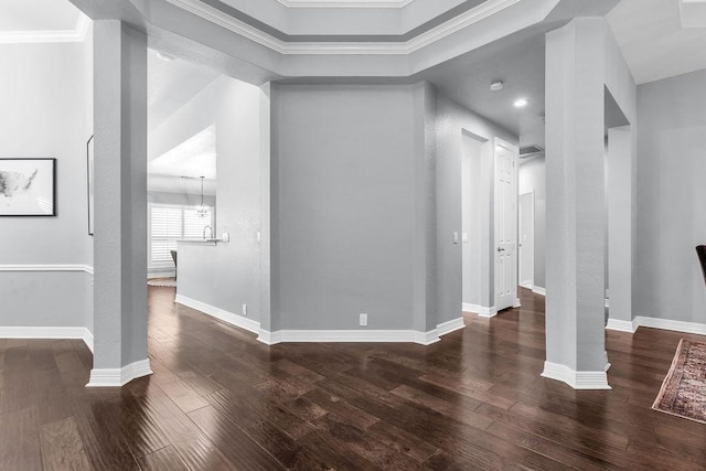 interior space featuring dark wood-style floors, baseboards, and ornate columns