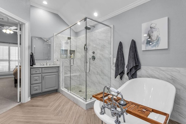 full bath featuring ornamental molding, a stall shower, vaulted ceiling, and a freestanding bath