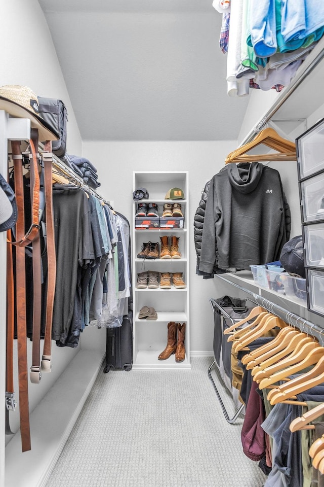 spacious closet featuring carpet and vaulted ceiling