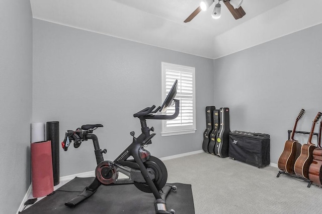 workout area featuring carpet floors, ceiling fan, baseboards, and vaulted ceiling