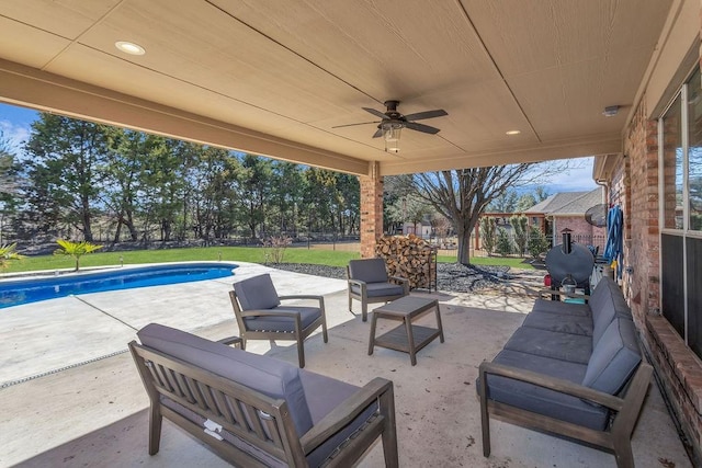 view of patio / terrace featuring a ceiling fan, an outdoor pool, an outdoor living space, and fence