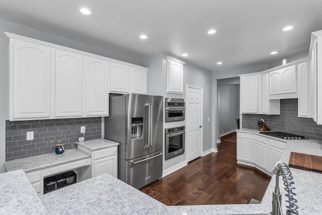 kitchen with stainless steel appliances, recessed lighting, dark wood-type flooring, and white cabinetry