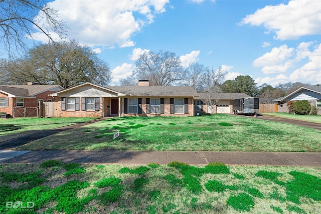 ranch-style home featuring a garage, a chimney, a front yard, and fence