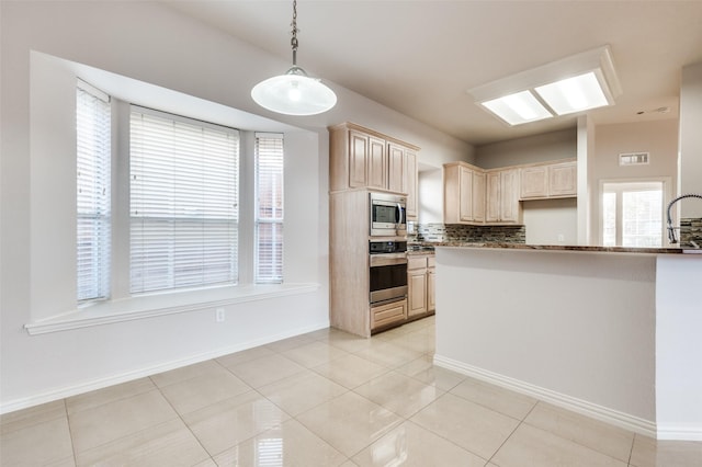 kitchen featuring light tile patterned floors, stainless steel appliances, backsplash, and light brown cabinetry