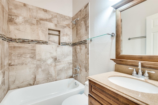 full bathroom with a textured wall,  shower combination, vanity, and toilet