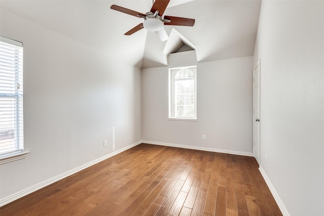 additional living space featuring a ceiling fan, baseboards, vaulted ceiling, and wood finished floors