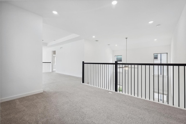 empty room with baseboards, carpet, and recessed lighting