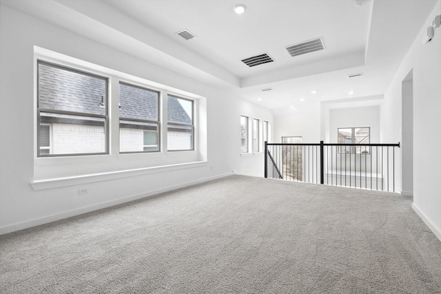 spare room with baseboards, visible vents, and carpet flooring