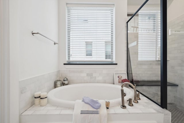 full bath featuring a shower stall and a bath