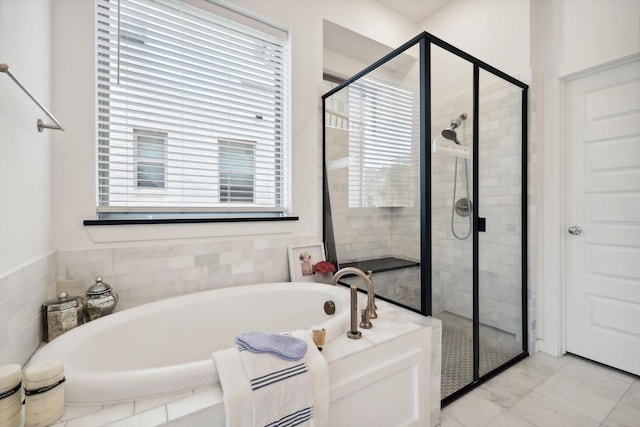 full bath featuring a stall shower and a garden tub