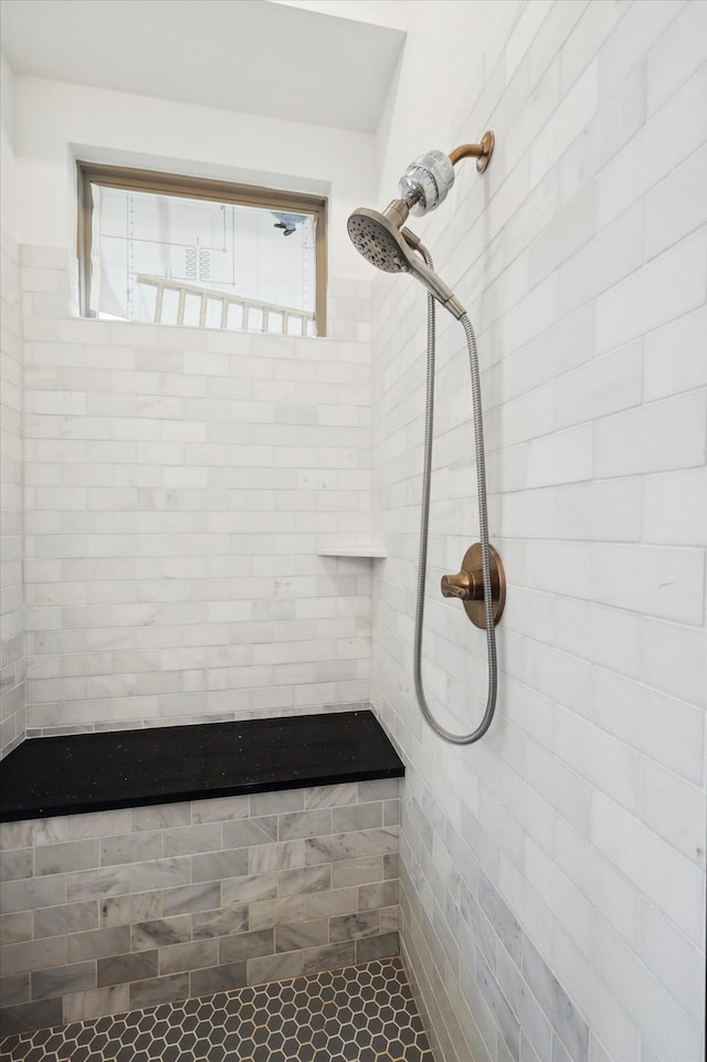 bathroom with tiled shower